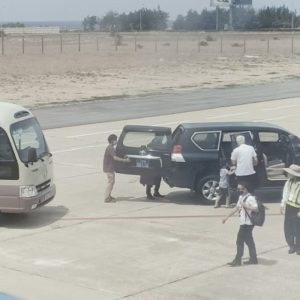 Deputy Secretary Phu Yen drives his car close to the plane to pick up his daughter