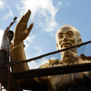 What do critics say about Vietnam continuing to build statues of Ho Chi Minh?