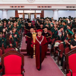 Hanoi National University requests the Rector of its Economics College to report on graduation ceremony attire
